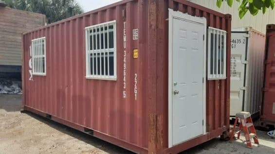 A red shipping container with a sliding window