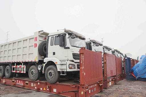 Lorries on flat rack containers