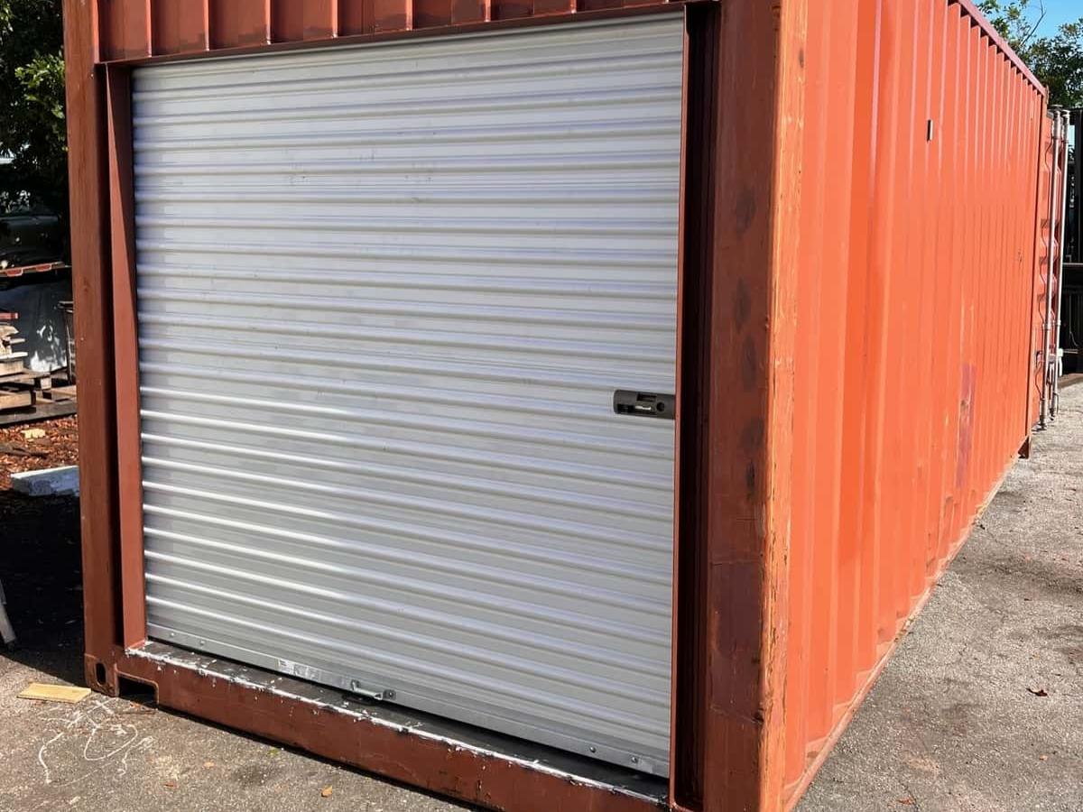 Red shipping container with roll up door