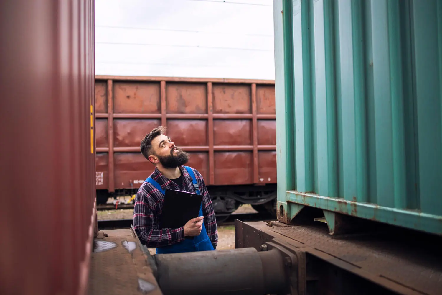A worker inspects a container to find the right shipping container size.