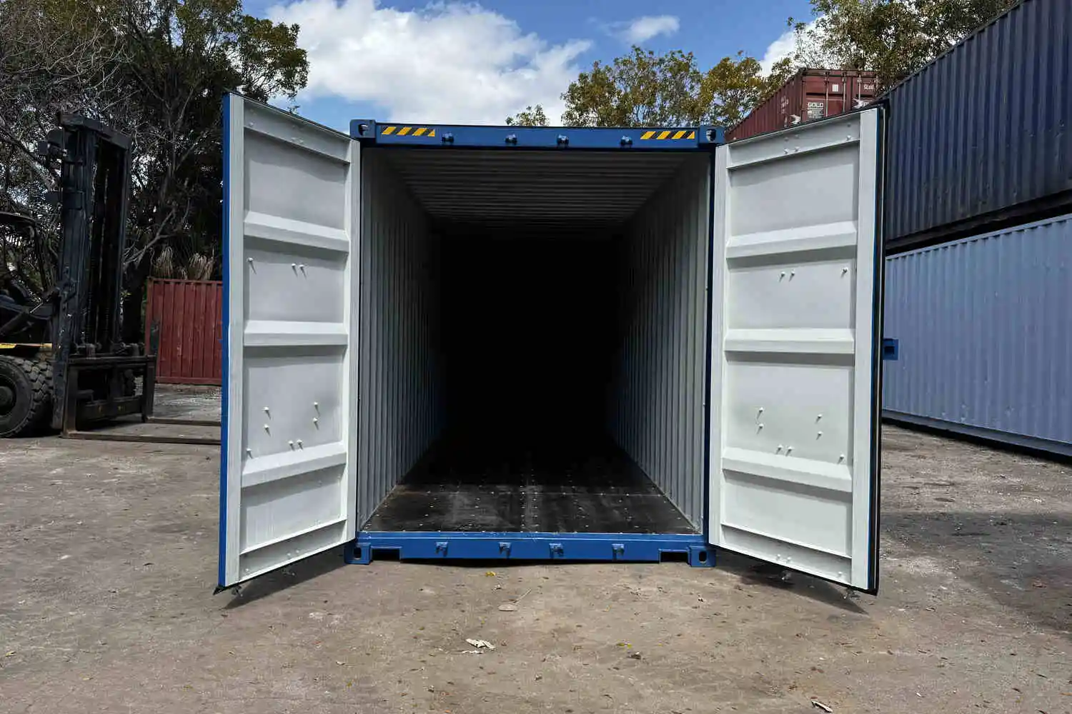 Blue shipping containers with two doors open